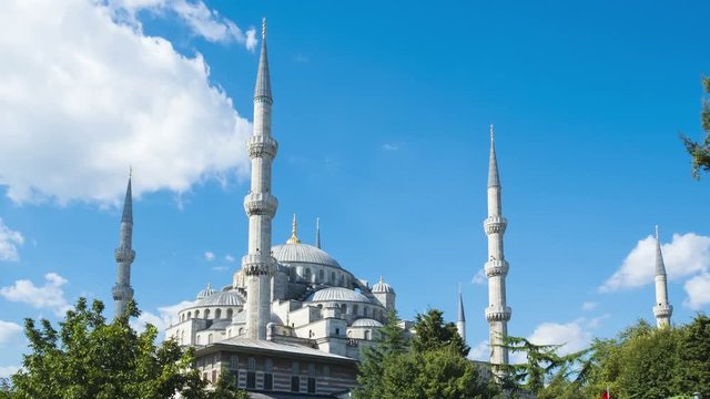 Zoom out time-lapse of the Blue Mosque or Sultan Ahmed Mosque with moving clouds on blue sky day in Istanbul, Turkey. 4k 24fps