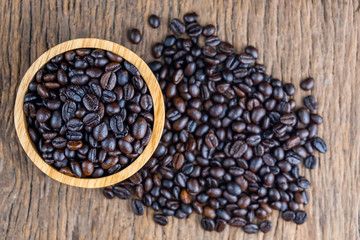 coffee beans on wooden bowl isolated top viwe on old wood background.