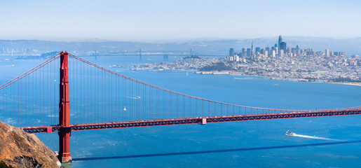 Aerial view of Golden Gate Bridge; the San Francisco skyline visible in the background; California - obrazy, fototapety, plakaty