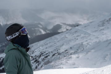 Fototapeta na wymiar Athletic female snowboarder at mountain summit Breckenridge