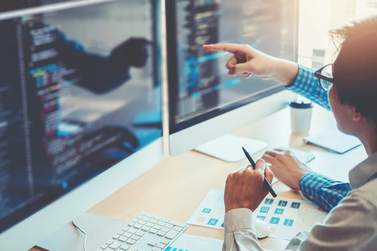 Developing programmer Team Development Website design and coding technologies working in software company office