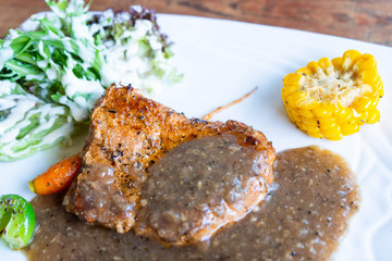 pork steak with black pepper and salad