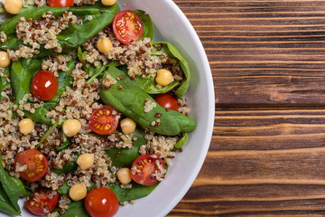 Spinach salad with quinoa , tomatoes and chickpea