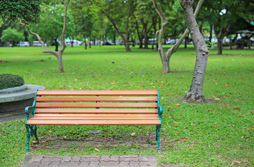 chairs in the public park with fall dried leaves around. Feel lonely and peaceful.