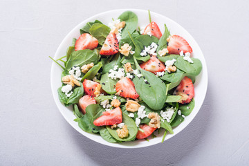 Strawberry salad with spinach , cheese and walnut . Healthy food