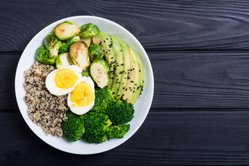 Buddha bowl with quinoa , eggs , avocado , brussels sprouts and broccoli