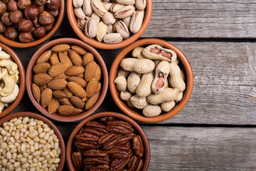 Mix of nuts : Pistachios, almonds , walnuts , pine nut , hazelnuts and cashew . Snack in bowl backgrond