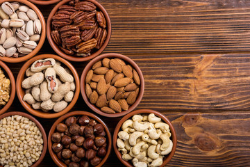Mix of nuts : Pistachios, almonds , walnuts , pine nut , hazelnuts and cashew . Snack in bowl backgrond