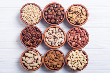 Mix of nuts : Pistachios, almonds , walnuts , pine nut , hazelnuts and cashew . Snack in bowl backgrond