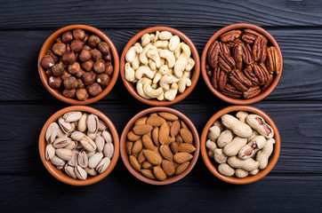 Mix of nuts : Pistachios, almonds , walnuts , pine nut , hazelnuts and cashew . Snack in bowl backgrond