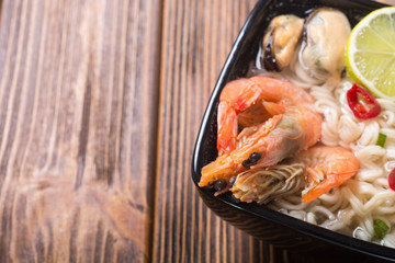 Instant noodles soup with shrimps and mssels . Asian food