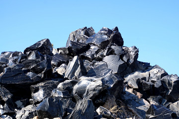 Large chunks of black obsidian glass exposed