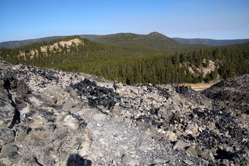 Large chunks of black obsidian glass exposed