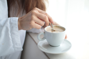 young woman with cup of coffee