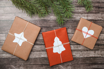 Christmas gifts with fir-tree on wooden background.