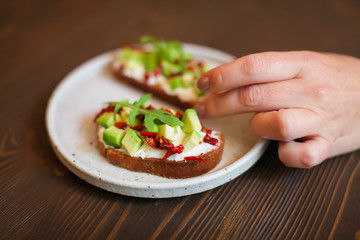 freshly prepared sandwiches with avocado, rye bread, tomatoes, concept of healthy food, nutrition and omega fatty acids