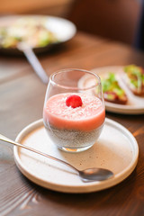 Chia pudding in glass with fresh berry. Superfoods healthy breakfast concept