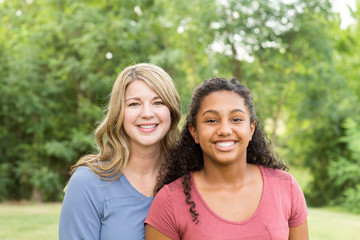 Mother and son laughing and playing at the park.