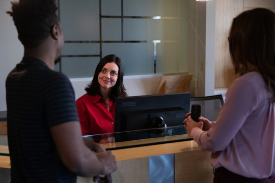 Friendly Receptionist In Business Lobby