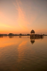 Amazing panoramic view of Gadisar or Gadi Sagar Lake with the view of historical building and temple during sunrise in Jaisalmer, India.