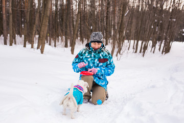 Fototapeta na wymiar Jack Russell Terrier dog with owner woman playing in the winter outdoors.