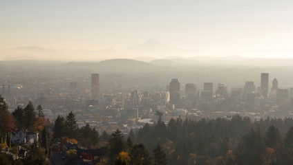 Portland Oregon downtown skyline at sunrise with Mt Hood in the distance..