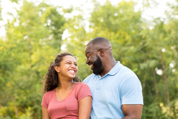 Father and his son laughing and playing at the park.