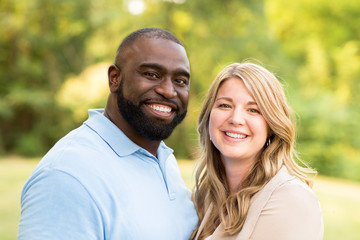Fototapeta premium Loving mixed race couple hugging and laughing.