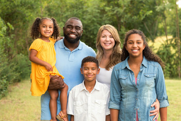 Portrait of a multi ethnic family laughing. - Powered by Adobe