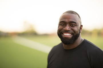 Portrait of an African American Football coach smiling.