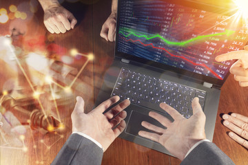 Stock market investment concept gain and profits with candlestick charts and numbers while financial business team debates and meets to discuss.