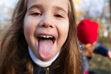 portrait of a girl sticking tongue out © photoguns