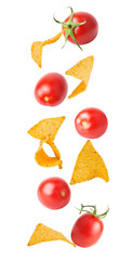 Flying potato chips and tomato isolated on white