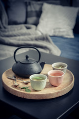 Black iron asian tea set on wooden tray
