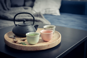 Black iron asian tea set on wooden tray