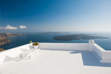 Chaise lounge on the terrace with sea view. Santorini island, Greece