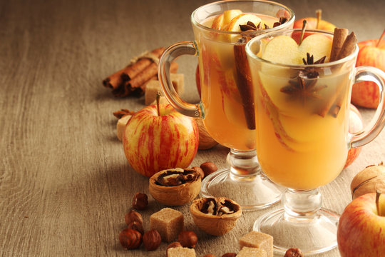 Two cups with hot cider in cold season with cinnamon and anise