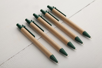 Ball pens on a white wooden background