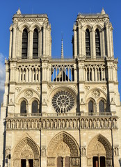 Notre Dame Cathedral. Paris, France. Gothic facade with blue sky.