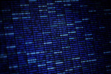 Computer display screen with blue binary code moving in the background. blur defocus blue bokeh light. technology graphic design background concepts