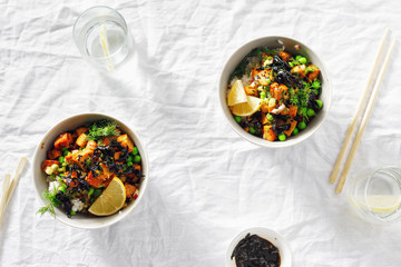 Two vegetarian poke bowl Tofu rice seaweed green peas vegetarian food Top view flat lay