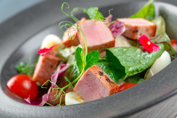 Green salad with cube slices of ham