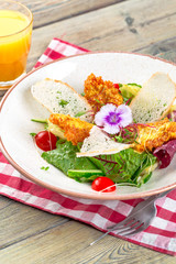 Fresh salad with chicken breast, arugula and tomato. Top view