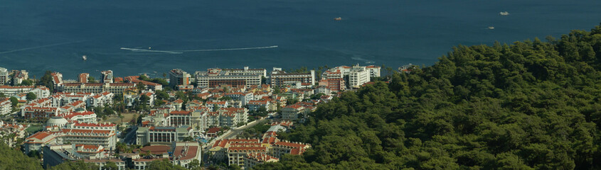 Nature landscape with a city by the shore of the sea between the hills. mountain town panorama