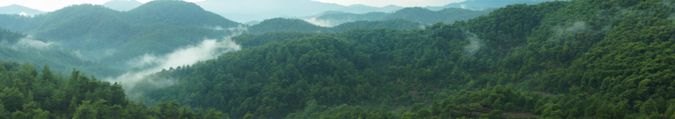 Mountain panorama with a dramatic sky background