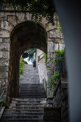 Fototapeta na wymiar Running man in old city stone steps