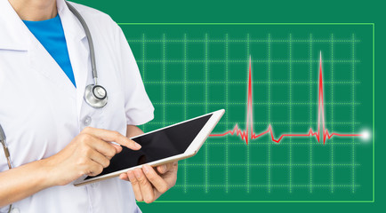 Doctor touching screen tablet on green graph background.