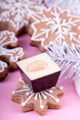 Christmass New Year decorations. Greeting card. Milk chocolate candy, gingerbread cookies. Tender pink color. Vintage style.