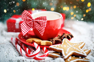 Merry Christmas and happy New year. Cup of cocoa, cookies, gifts and fir-tree branches on a white wooden table. Selective focus. Christmas background. Horizontal.