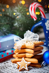 Merry Christmas and happy New year. Cup cocoa, cookies, gifts and fir-tree branches on a wooden table. Selective focus. Christmas background.